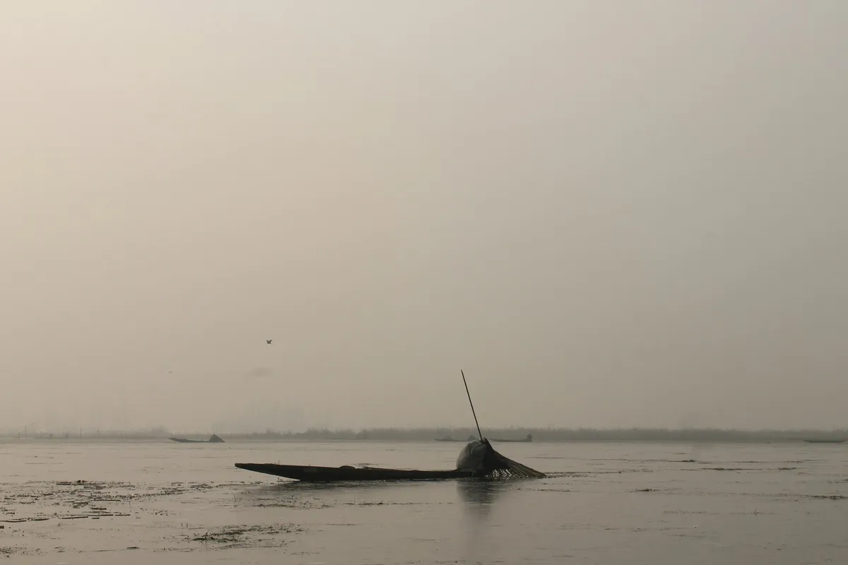 Photo of a fisher man on his boat.